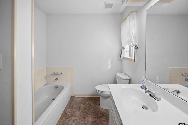 bathroom featuring a garden tub, visible vents, toilet, vanity, and baseboards