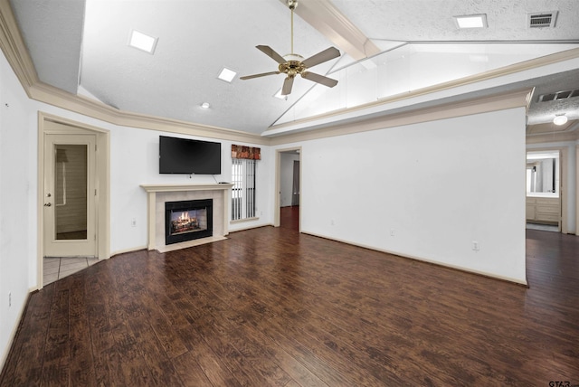 unfurnished living room with vaulted ceiling with beams, a fireplace, wood finished floors, and visible vents