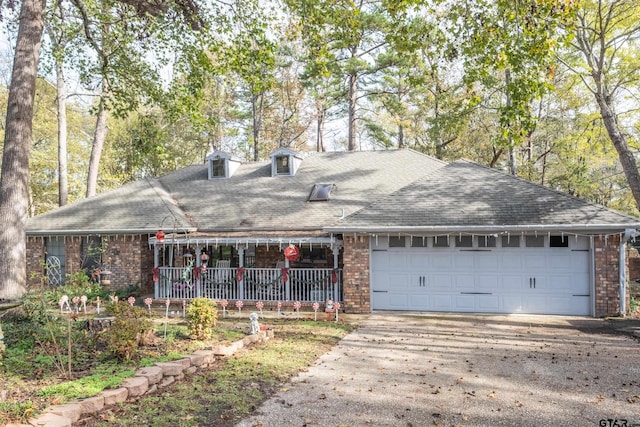 view of front facade featuring covered porch and a garage