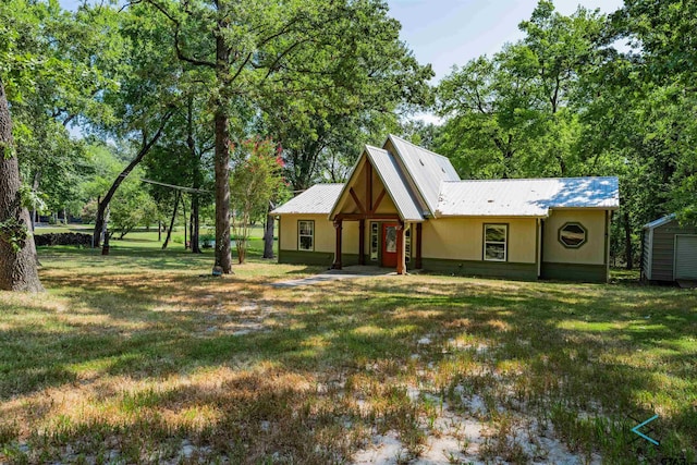 rear view of property with a lawn