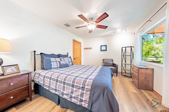 bedroom with ceiling fan and light hardwood / wood-style flooring