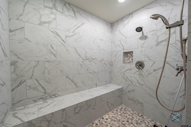 bathroom with a tile shower