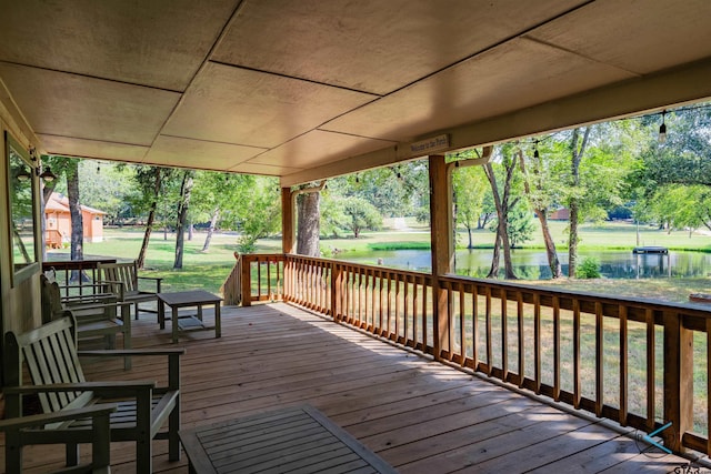 wooden deck featuring a water view