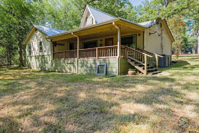 view of side of home featuring central AC and a yard