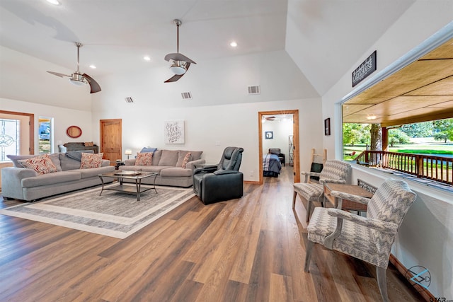 living room with lofted ceiling, ceiling fan, hardwood / wood-style floors, and a wealth of natural light