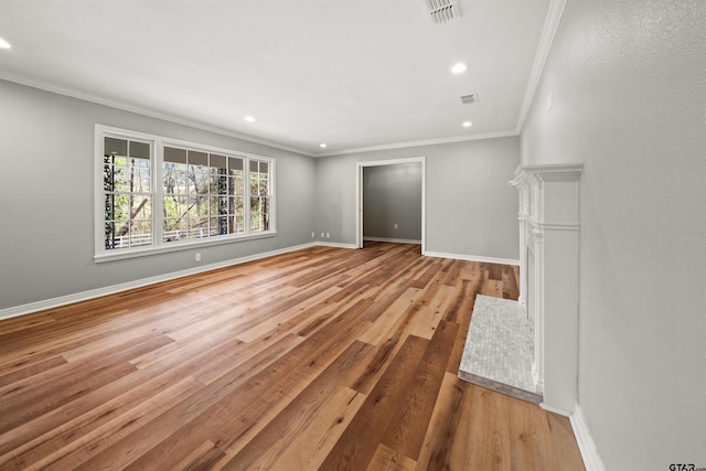 unfurnished living room with ornamental molding, recessed lighting, visible vents, and wood finished floors
