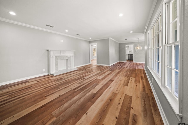 unfurnished living room featuring recessed lighting, visible vents, and baseboards