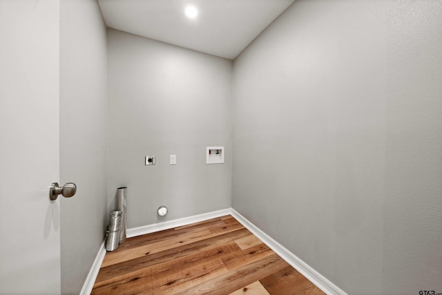 laundry area featuring laundry area, light wood-style flooring, electric dryer hookup, washer hookup, and baseboards