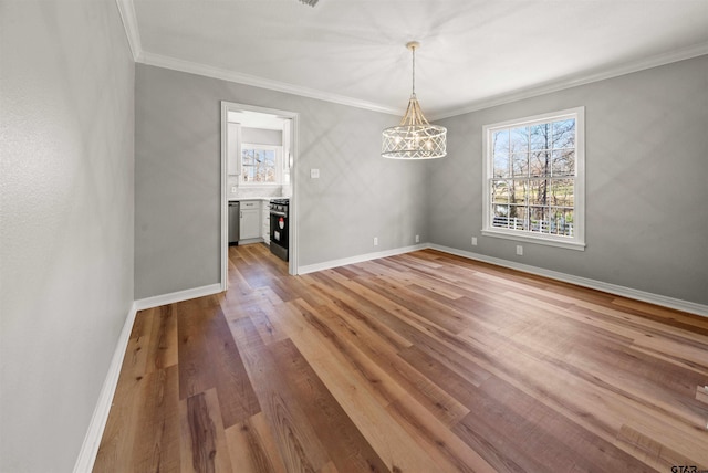 unfurnished dining area with ornamental molding, a notable chandelier, baseboards, and light wood-style floors