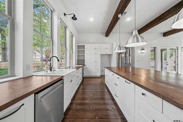 kitchen featuring dishwasher, beam ceiling, dark wood-style flooring, and butcher block countertops