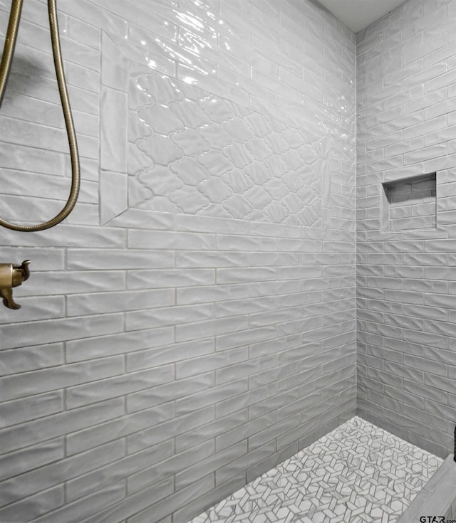 bathroom with a tile shower