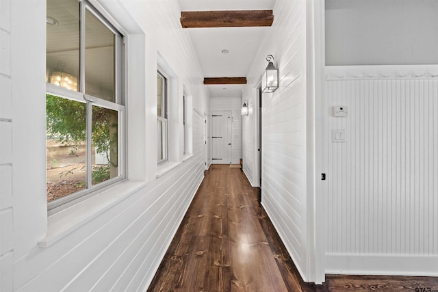 hall with beamed ceiling and dark wood-style floors