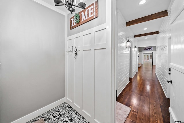 hallway featuring beamed ceiling, dark wood-style floors, recessed lighting, baseboards, and a chandelier