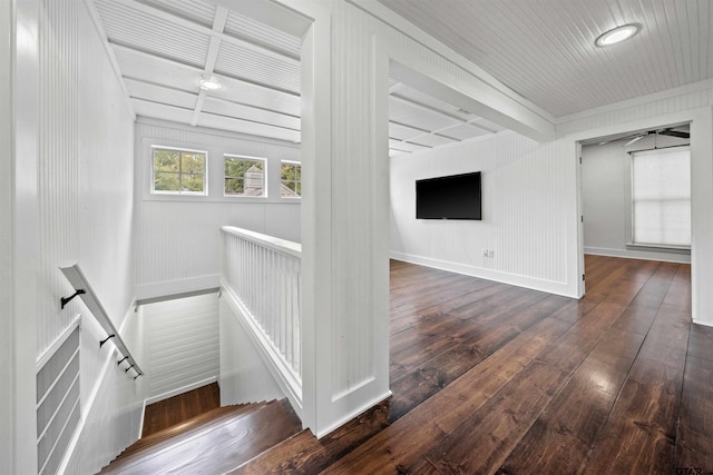 staircase with beam ceiling, baseboards, and hardwood / wood-style flooring