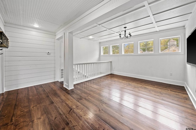 interior space featuring a chandelier, baseboards, and hardwood / wood-style floors