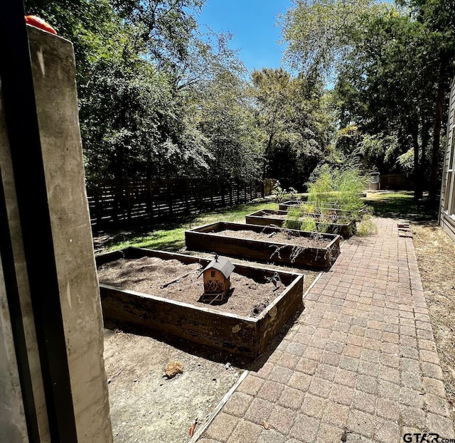 view of patio / terrace with fence and a garden