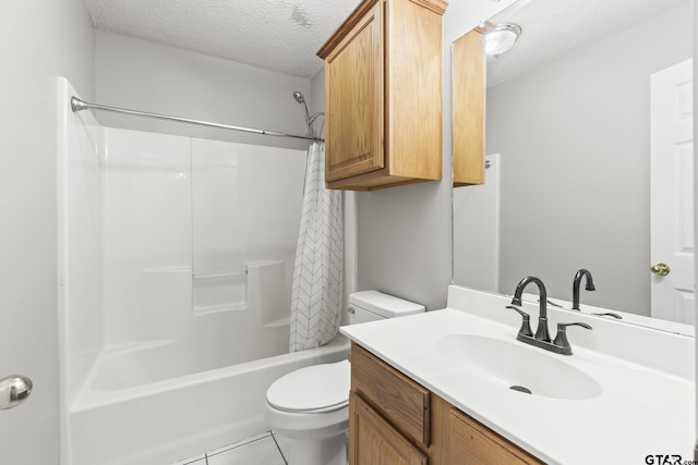 full bath featuring tile patterned floors, toilet, vanity, a textured ceiling, and shower / tub combo