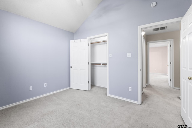unfurnished bedroom with carpet floors, baseboards, vaulted ceiling, and visible vents