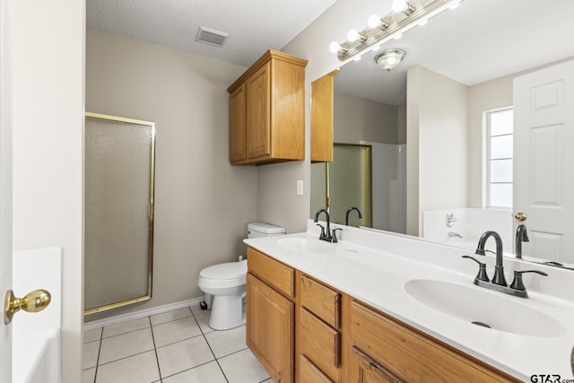 full bathroom featuring a sink, tile patterned floors, and a shower stall