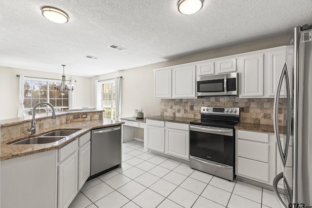 kitchen featuring visible vents, white cabinetry, a sink, and appliances with stainless steel finishes