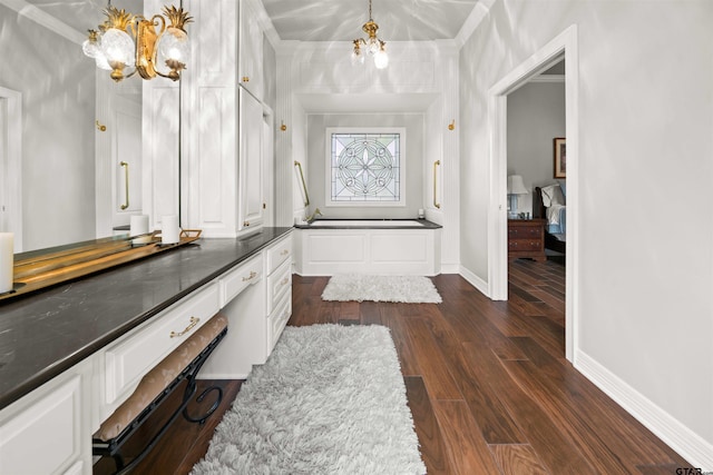 bathroom with wood-type flooring, a notable chandelier, and ornamental molding