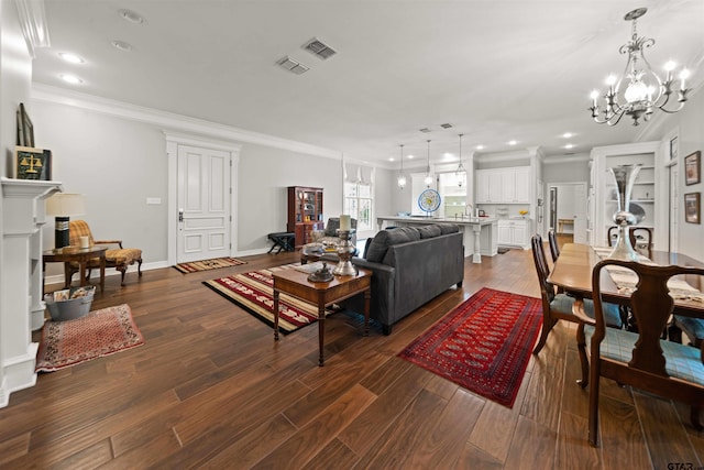 living room with crown molding, dark hardwood / wood-style flooring, and a notable chandelier