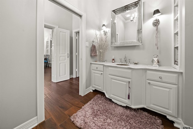 bathroom with hardwood / wood-style floors, vanity, and ornamental molding