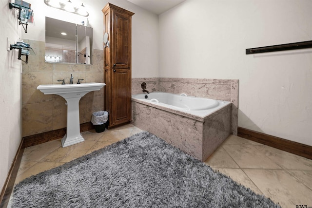 bathroom with tile patterned flooring and tiled bath