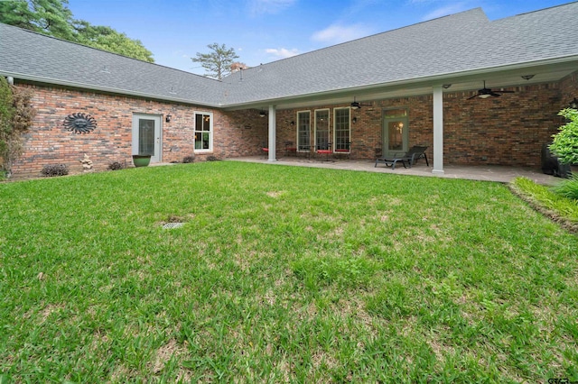 back of house featuring ceiling fan, a yard, and a patio