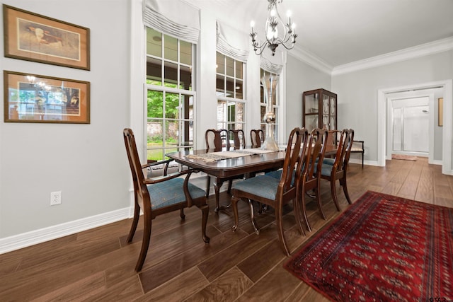 dining area with dark hardwood / wood-style floors, ornamental molding, and a chandelier