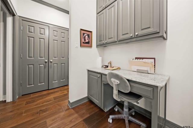 office area featuring dark wood-type flooring and built in desk