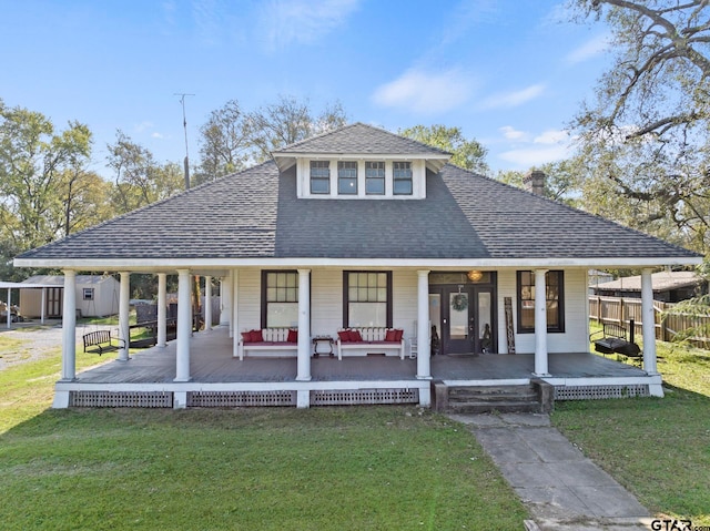 view of front of home featuring covered porch and a front yard