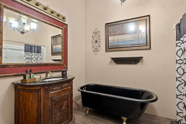 bathroom with hardwood / wood-style floors, vanity, and a tub