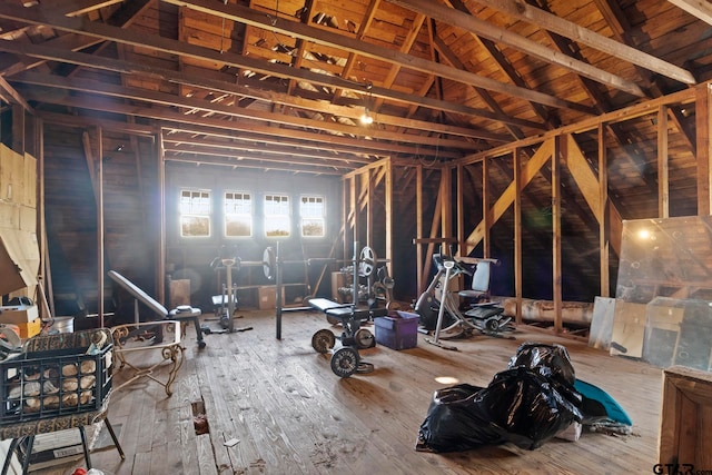 miscellaneous room featuring lofted ceiling and hardwood / wood-style flooring