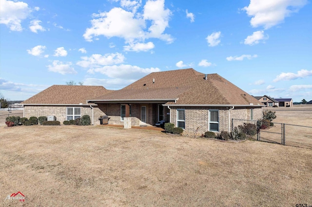 rear view of house featuring a lawn