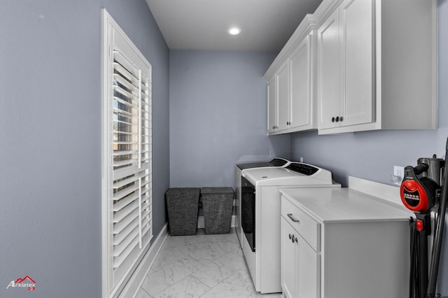 laundry area with cabinets and washing machine and clothes dryer