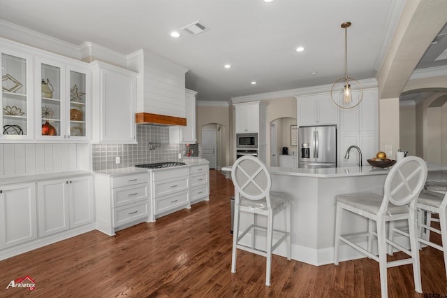 kitchen featuring white cabinetry, appliances with stainless steel finishes, dark hardwood / wood-style flooring, and hanging light fixtures