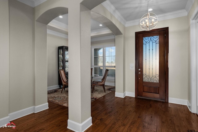 entryway featuring ornamental molding, a chandelier, and dark hardwood / wood-style flooring