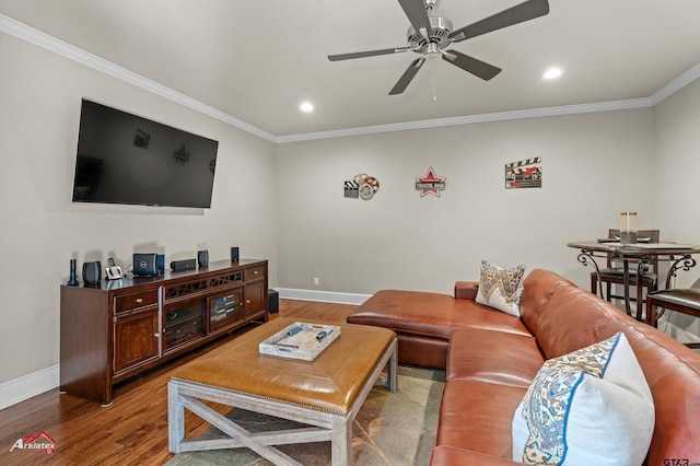 living room with hardwood / wood-style flooring, ornamental molding, and ceiling fan