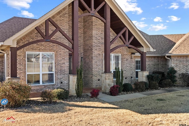 doorway to property with a lawn