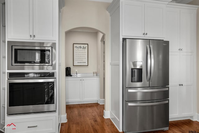 kitchen featuring white cabinetry, appliances with stainless steel finishes, and dark hardwood / wood-style floors