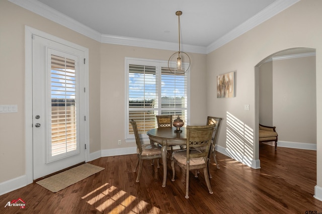 dining area with a healthy amount of sunlight, dark hardwood / wood-style floors, and ornamental molding