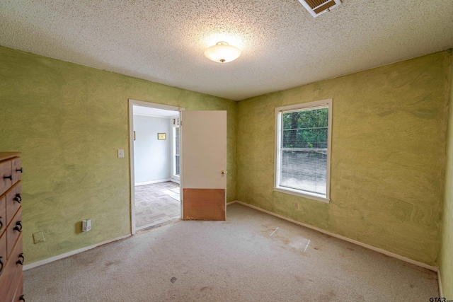 102 King Henry Rd, Scroggins, TX 75480 - carpeted spare room with a textured wall, baseboards, a textured ceiling, and visible vents
