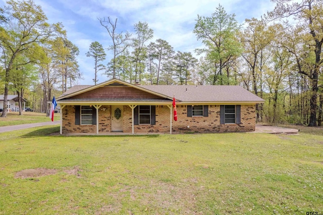102 King Henry Rd, Scroggins, TX 75480 - ranch-style house featuring covered porch, brick siding, and a front yard