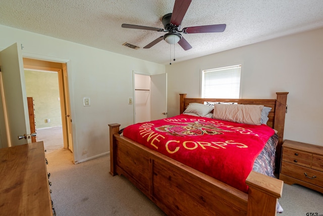102 King Henry Rd, Scroggins, TX 75480 - bedroom featuring visible vents, light carpet, ceiling fan, and a textured ceiling