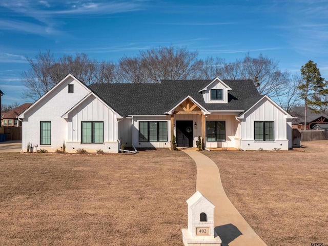 modern inspired farmhouse featuring a front lawn