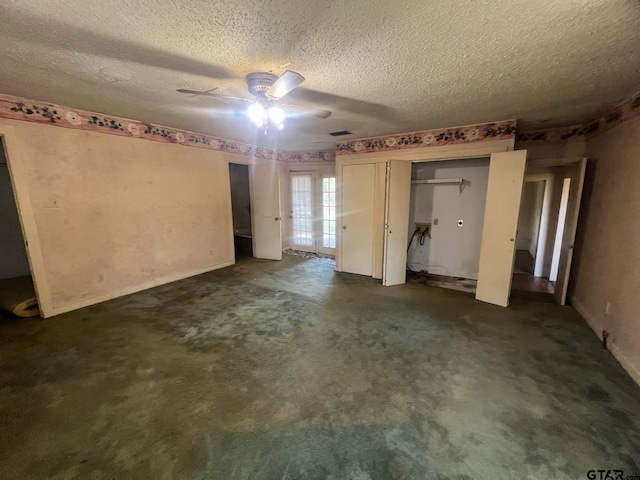 unfurnished bedroom featuring a textured ceiling, ceiling fan, and dark carpet