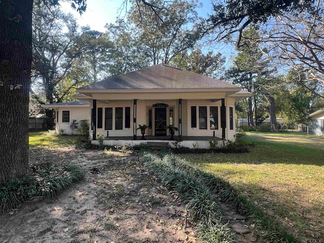 view of front of house with a porch and a front yard