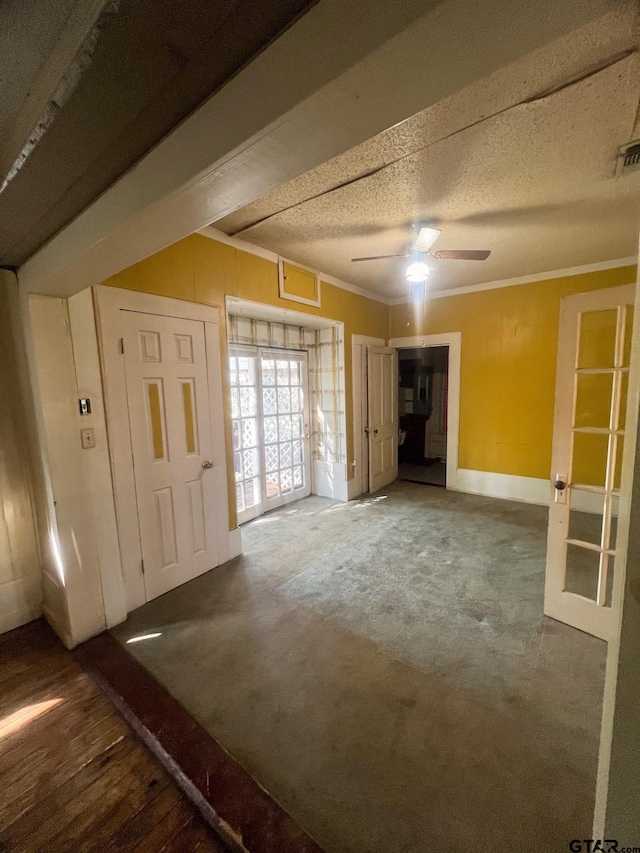625 S Buffalo St, Canton, TX 75103 - unfurnished living room featuring ceiling fan, ornamental molding, a textured ceiling, and carpet floors