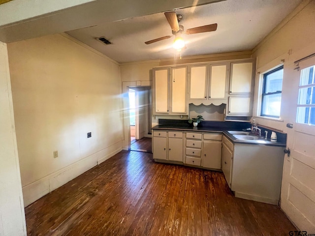 625 S Buffalo St, Canton, TX 75103 - kitchen with dark wood finished floors, white cabinets, a ceiling fan, dark countertops, and crown molding